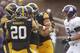 IOWA CITY, IOWA - OCTOBER 26: Linebacker James Morris #44 of the Iowa Hawkeyes is congratulated by linebacker Christian Kirksey #20 and defensive end Nate Meier #34 after sacking quarterback Kain Colter (not pictured) of the Northwestern Wildcats in the