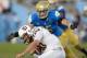 Nov 23, 2013; Pasadena, CA, USA; Arizona State Sun Devils quarterback Taylor Kelly (10) tries to run past UCLA Bruins linebacker Jordan Zumwalt (35) during first quarter action at Rose Bowl. Mandatory Credit: Robert Hanashiro-USA TODAY Sports