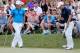 PONTE VEDRA BEACH, FL - MAY 10: Jordan Spieth of the United States (R) saves par on the 18th hole as Martin Kaymer of Germany look on during the third round of THE PLAYERS Championship on the stadium course at TPC Sawgrass on May 10, 2014 in Ponte Vedra