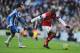 BRIGHTON, ENGLAND - JANUARY 26: Abou Diaby of Arsenal is watched by David Lopez of Brighton & Hove Albion during the FA Cup with Budweiser Fourth Round match between Brighton & Hove Albion and Arsenal at Amex Stadium on January 26, 2013 in Brighton, Engl