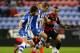 WIGAN, ENGLAND - MAY 09: James McArthur of Wigan Athletic holds off a challenge from Danny Simpson of Queens Park Rangers during the Sky Bet Championship Play Off Semi Final first leg match between Wigan Athletic and Queens Park Rangers at DW Stadium on