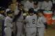 25 Oct 2000: Derek Jeter #2 of the New York Yankees is congratulated as he heads into the dugout after hitting a solo home run in the first inning against the New York Mets during Game 4 of the World Series at Shea Stadium in Flushing, New York. The Yank