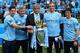 MANCHESTER, ENGLAND - MAY 11: (L-R) Manchester City Goalkeeping Coach Xabier Mancisidor, Joint Assistant Manager Brian Kidd, Manager Manuel Pellegrini, Joint Assistant Manager Ruben Cousillas and Fitness Coach Jose Cabello pose with the trophy after the