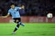 MONTEVIDEO, URUGUAY - NOVEMBER 20: Luis Suarez of Uruguay runs with the ball during leg 2 of the FIFA World Cup Qualifier match between Uruguay and Jordan at Centenario Stadium Stadium on November 20, 2013 in Montevideo, Uruguay. (Photo by Friedemann Vo