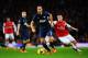 LONDON, ENGLAND - FEBRUARY 12: Rio Ferdinand of Manchester United holds off the challenge of Mesut Ozil of Arsenal challenge for the ball during the Barclays Premier League match between Arsenal and Manchester United at the Emirates Stadium on February 1