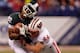 INDIANAPOLIS, IN - DECEMBER 03: Keshawn Martin #82 of the Michigan State Spartans loses his helmet as he is hit by Chris Borland #44 of the Wisconsin Badgers during the third quarter of the Big 10 Conference Championship Game at Lucas Oil Stadium on Dece