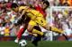 LIVERPOOL, ENGLAND - AUGUST 15: Samir Nasri of Arsenal is challenged by Javier Mascherano of Liverpool during the Barclays Premier League match between Liverpool and Arsenal at Anfield on August 15, 2010 in Liverpool, England. (Photo by Clive Brunskill/