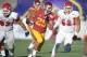 Dec 21, 2013; Las Vegas, NV, USA; Southern California Trojans tailback Ty Isaac (29) is pursued by Fresno State Bulldogs nose guard Tyeler DavisoN (92) and defensive end Nikko Motta (52) in the Las Vegas Bowl at Sam Boyd Stadium. USC defeated Fresno State