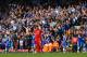 LIVERPOOL, ENGLAND - APRIL 27: A dejected Steven Gerrard of Liverpool looks on as the Chelsea fans celebrate after Willian of Chelsea scored their second goal during the Barclays Premier League match between Liverpool and Chelsea at Anfield on April 27,
