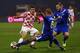 ZAGREB, CROATIA - NOVEMBER 19: Mateo Kovacic of Croatia is challenged by Ragnar Sigurdsson and Aron Gunnarsson (L-R) of Iceland during the FIFA 2014 World Cup Qualifier play-off second leg match between Croatia and Iceland at Maksimir Stadium on November