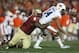 Jan 6, 2014; Pasadena, CA, USA; Auburn Tigers quarterback Nick Marshall (14) is tackled by Florida State Seminoles defensive tackle Timmy Jernigan (8) during the second half of the 2014 BCS National Championship game at the Rose Bowl. Mandatory Credit: Ma