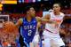 SYRACUSE, NY - FEBRUARY 01: Quinn Cook #2 of the Duke Blue Devils drives to the basket past Tyler Ennis #11 of the Syracuse Orange during overtime at the Carrier Dome on February 1, 2014 in Syracuse, New York. Syracuse defeated Duke 91-89 in overtime. (