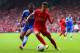 LIVERPOOL, ENGLAND - APRIL 27: Ashley Cole of Chelsea and Philippe Coutinho of Liverpool compete for the ball during the Barclays Premier League match between Liverpool and Chelsea at Anfield on April 27, 2014 in Liverpool, England. (Photo by Clive Bruns