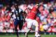 LONDON, ENGLAND - MAY 04: Mesut Ozil (R) of Arsenal controls the ball ahead of Youssuf Mulumbu (L) of West Bromwich Albion during the Barclays Premier League match between Arsenal and West Bromwich Albion at the Emirates Stadium on May 4, 2014 in London,