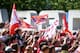 LONDON, ENGLAND - MAY 18: Arsenal fans wave their flags during the Arsenal FA Cup Victory Parade on May 18, 2014 in London, England, (Photo by Charlie Crowhurst/Getty Images)