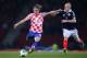 GLASGOW, SCOTLAND - OCTOBER 15: Luka Modric of Croatia shoots watched by Steven Naismith of Scotland during the FIFA 2014 World Cup Qualifying Group A match between Scotland and Croatia at Hampden Park on October 15, 2013 in Glasgow, Scotland. (Photo by