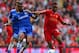 LIVERPOOL, ENGLAND - APRIL 27: Ashley Cole of Chelsea and Raheem Sterling of Liverpool battle for the ball during the Barclays Premier League match between Liverpool and Chelsea at Anfield on April 27, 2014 in Liverpool, England. (Photo by Clive Brunskil