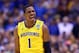 INDIANAPOLIS, IN - MARCH 30: Glenn Robinson III #1 of the Michigan Wolverines celebrates after a basket in the second half against the Kentucky Wildcats during the midwest regional final of the 2014 NCAA Men's Basketball Tournament at Lucas Oil Stadium o