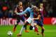 MANCHESTER, ENGLAND - FEBRUARY 18: Xavi Hernandez of Barcelona battles with Yaya Toure of Manchester City during the UEFA Champions League Round of 16 first leg match between Manchester City and Barcelona at the Etihad Stadium on February 18, 2014 in Man
