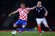 GLASGOW, SCOTLAND - OCTOBER 15: Luka Modric of Croatia shoots watched by Steven Naismith of Scotland during the FIFA 2014 World Cup Qualifying Group A match between Scotland and Croatia at Hampden Park on October 15, 2013 in Glasgow, Scotland. (Photo by