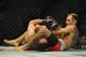 May 24, 2014; Las Vegas, NV, USA; Tony Ferguson (red) locks onto Katsunori Kikuno (blue) during their UFC 173 welterweight bout at MGM Grand Garden Arena. Ferguson won the bout by TKO. Mandatory Credit: Stephen R. Sylvanie-USA TODAY Sports
