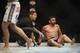 May 24, 2014; Las Vegas, NV, USA; Jamie Varner (red) sits on the mat unable to continue his fight against James Krause (blue) after hurting his ankle during their UFC 173 bantamweight bout at MGM Grand Garden Arena. Krause won his bout by TKO. Mandatory