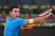 MADRID, SPAIN - MAY 06: Dominic Thiem of Austria plays a backhand against Stanislas Wawrinka of Switzerland in their second round match during day four of the Mutua Madrid Open tennis tournament at the Caja Magica on May 6, 2014 in Madrid, Spain. (Photo