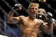 May 24, 2014; Las Vegas, NV, USA; TJ Dillashaw (blue) celebrates after a successful third round against opponent Renan Barao (not pictured) during their UFC 173 bantamweight championship bout at MGM Grand Garden Arena. Dillashaw won the bout by way of TK