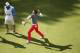 VIRGINIA WATER, ENGLAND - MAY 25: Rory McIlroy of Northern Ireland throws his ball to the crowd after holing a birdie putt on the 18th green during day four of the BMW PGA Championship at Wentworth on May 25, 2014 in Virginia Water, England. (Photo by A