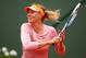 PARIS, FRANCE - MAY 26: Maria Sharapova of Russia returns a shot during her women's singles match against Ksenia Pervak of Russia on day two of the French Open at Roland Garros on May 26, 2014 in Paris, France. (Photo by Clive Brunskill/Getty Images)