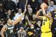 IOWA CITY, IA - JANUARY 28: Guard Roy Devyn Marble #4 of the Iowa Hawkeyes takes a shot during the second half in front of guard Gary Harris #14 of the Michigan State Spartans on January 28, 2014 at Carver-Hawkeye Arena, in Iowa City, Iowa. (Photo by Mat