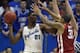LAWRENCE, KS - FEBRUARY 24: Joel Embiid #21 of the Kansas Jayhawks looks to pass the ball against D.J. Bennett #31 of the Oklahoma Sooners in the second half at Allen Fieldhouse on February 24, 2014 in Lawrence, Kansas. Kansas won 83-75. (Photo by Ed Zu