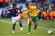BLOEMFONTEIN, SOUTH AFRICA - JUNE 14: Yuichi Komano of Japan and Eric Choupo Moting of Cameroon battle for the ball during the 2010 FIFA World Cup South Africa Group E match between Japan and Cameroon at the Free State Stadium on June 14, 2010 in Mangaun