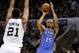 May 19, 2014; San Antonio, TX, USA; Oklahoma City Thunder guard Thabo Sefolosha (25) shoots the ball over San Antonio Spurs forward Tim Duncan (21) in game one of the Western Conference Finals in the 2014 NBA Playoffs at AT&T Center. Mandatory Credit: Soo
