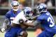 Jul 28, 2012; Albany, NY, USA; New York Giants running back David Wilson (34) carries the ball against defensive back Will Hill (38) and defensive back Antwaun Molden (22) during training camp at University Field at SUNY Albany. Mandatory Credit: Mark L.