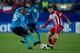 MADRID, SPAIN - DECEMBER 11: Emiliano Insua (R) of Atletico de Madrid competes for the ball with Fernando Reges (L) of FC Porto during the UEFA Champions League Group G match at Vicente Calderon Stadium on December 11, 2013 in Madrid, Spain. (Photo by Go