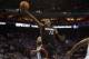 Apr 26, 2014; Charlotte, NC, USA; Miami Heat guard Mario Chalmers (15) goes up for a shot against Charlotte Bobcats forward Josh McRoberts (11) during the first half in game three of the first round of the 2014 NBA Playoffs at Time Warner Cable Arena. Man