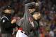 BOSTON, MA - MAY 30: Filling in for ejected manager John Farrell #53 of the Boston Red Sox, bench coach Torey Lovullo #17 of the Boston Red Sox throws his cap while arguing with umpiring crew chief Jeff Kellogg #8 after Mike Carp #37 of the Boston Red So