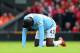 LIVERPOOL, ENGLAND - APRIL 13: Yaya Toure of Manchester City reacts to an injury during the Barclays Premier League match between Liverpool and Manchester City at Anfield on April 13, 2014 in Liverpool, England. (Photo by Alex Livesey/Getty Images)