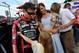 Jeff Gordon's daughter Ella seeks a hug from her father prior to the recent Coca-Cola 600 while wife Ingrid Vandebosch (with son Leo in arms) looks on.