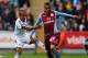 SWANSEA, WALES - APRIL 26: Wayne Routledge of Swansea City battles with Ryan Bertrand of Aston Villa during the Barclays Premier League match between Swansea City and Aston Villa at Liberty Stadium on April 26, 2014 in Swansea, Wales. (Photo by Paul Tho