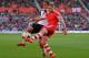 SOUTHAMPTON, ENGLAND - MARCH 15: Luke Shaw of Southampton clears the ball away from Johan Elmander of Norwich during the Barclays Premier League match between Southampton and Norwich City at St Mary's Stadium on March 15, 2014 in Southampton, England. (