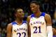 LAWRENCE, KS - NOVEMBER 22: Andrew Wiggins #22 of the Kansas Jayhawks talks with Joel Embiid #21 as they walk onto the floor after a timeout during the game against the Towson Tigers at Allen Fieldhouse on November 22, 2013 in Lawrence, Kansas. (Photo by