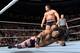 Rusev prepares to crush Xavier Woods.