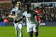 SWANSEA, WALES - FEBRUARY 08: Swansea striker Wilfried Bony (r) celebrates with Chico Flores after scoring the third goal during the Barclays Premier League match between Swansea City and Cardiff City at Liberty Stadium on February 8, 2014 in Swansea, Wa
