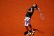PARIS, FRANCE - JUNE 06: Ernests Gulbis of Latvia serves during his men's singles semi-final match against Novak Djokovic of Serbia on day thirteen of the French Open at Roland Garros on June 6, 2014 in Paris, France. (Photo by Clive Brunskill/Getty Ima