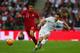 LONDON, ENGLAND - MAY 30: Jean Deza of Peru and Leighton Baines of England compete for the ball during the international friendly match between England and Peru at Wembley Stadium on May 30, 2014 in London, England. (Photo by Clive Rose/Getty Images)