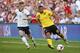 KANSAS CITY, KS - OCTOBER 11: Adrain Mariappa #19 of the Jamaica drives past Aron Johannsson #9 of the U.S. Men's National Soccer Team early in the first half at Sporting Park on October 11, 2013 in Kansas City, Kansas. (Photo by Kyle Rivas/Getty Images)