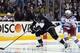 Jun 4, 2014; Los Angeles, CA, USA; Los Angeles Kings center Anze Kopitar (11) skates with the puck past New York Rangers center Brad Richards (19) in the third period during game one of the 2014 Stanley Cup Final at Staples Center. Mandatory Credit: Kirby