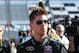 Jun 6, 2014; Long Pond, PA, USA; NASCAR Sprint Cup Series driver Denny Hamlin (11) walks to the garage after winning the pole position during qualifying for the Pocono 400 at Pocono Raceway. Mandatory Credit: Matthew O'Haren-USA TODAY Sports